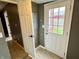 A hallway view, featuring a white door and tile flooring at 104 W Pearl St, Trafalgar, IN 46181