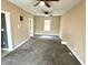 Image shows the living room with carpet flooring at 104 W Pearl St, Trafalgar, IN 46181