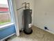 A utility room with a hot water tank and tile flooring at 104 W Pearl St, Trafalgar, IN 46181