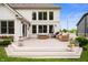 Beautiful outdoor deck with comfortable wicker furniture, a striped umbrella, and flowering plants at 10505 Golden Bear Way, Noblesville, IN 46060