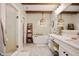 Bright bathroom features a soaking tub, walk-in shower, wood beams, and a decorative hanging light at 10505 Golden Bear Way, Noblesville, IN 46060