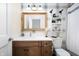 Bathroom features a modern wooden vanity, a toilet, and a mirror with modern fixtures at 10505 Golden Bear Way, Noblesville, IN 46060