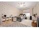Bright bedroom features an airplane print wall, a ceiling fan, and ample natural light from the window at 10505 Golden Bear Way, Noblesville, IN 46060