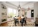 Cozy dining area with a round table, modern lighting, and built-in shelving at 10505 Golden Bear Way, Noblesville, IN 46060