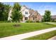 Charming two-story home with stone and white siding and a well-maintained lawn at 10505 Golden Bear Way, Noblesville, IN 46060