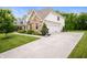 Attractive two-story home with stone accents, white siding, and a three-car garage at 10505 Golden Bear Way, Noblesville, IN 46060