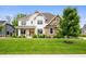 Charming two-story home with a combination of white siding and stone accents, plus a beautifully landscaped front yard at 10505 Golden Bear Way, Noblesville, IN 46060