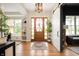 Elegant foyer with hardwood floors, a wooden front door, and stylish decor at 10505 Golden Bear Way, Noblesville, IN 46060