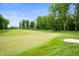Lush green golf course with a sand trap and a blue flag on the green at 10505 Golden Bear Way, Noblesville, IN 46060