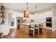 Bright kitchen with large island, white cabinetry, stainless steel appliances, and modern pendant lighting at 10505 Golden Bear Way, Noblesville, IN 46060