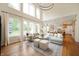 Bright living room with large windows, a comfortable sectional sofa, and open to kitchen at 10505 Golden Bear Way, Noblesville, IN 46060