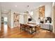 Spacious living room featuring hardwood floors, fireplace, and a decorative sliding barn door at 10505 Golden Bear Way, Noblesville, IN 46060