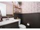 Chic powder room featuring dark wainscoting, patterned wallpaper, and modern fixtures at 10505 Golden Bear Way, Noblesville, IN 46060
