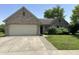 Charming brick home with attached garage and manicured lawn, offering curb appeal and functionality at 11014 Lake Run Dr, Fishers, IN 46038