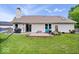 Spacious backyard with a patio, lush lawn, flower beds, and a charcoal grill at 11041 Limbach Cir, Indianapolis, IN 46236