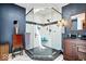 Elegant bathroom featuring a glass enclosed shower with bench and a vanity with dark granite countertop at 11041 Limbach Cir, Indianapolis, IN 46236