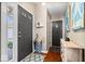 Charming entryway with hardwood floors, a coat closet, a blue umbrella holder, and art at 11041 Limbach Cir, Indianapolis, IN 46236