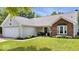 Attractive single-story house with a brick accent, a two-car garage, and a lush green lawn at 11041 Limbach Cir, Indianapolis, IN 46236