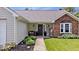 Inviting front entrance with a wreath, bench, and neatly arranged landscaping at 11041 Limbach Cir, Indianapolis, IN 46236