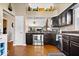 Modern kitchen features stainless steel appliances, dark wood cabinets, and wood flooring at 11041 Limbach Cir, Indianapolis, IN 46236