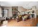 Spacious living room with a brick fireplace, hardwood floors and an open layout into the kitchen at 11041 Limbach Cir, Indianapolis, IN 46236