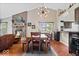 Cozy open-concept living room with a brick fireplace, and dining area at 11041 Limbach Cir, Indianapolis, IN 46236