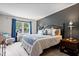Tranquil main bedroom featuring a queen size bed, blue curtains and lamps for cozy lighting at 11041 Limbach Cir, Indianapolis, IN 46236