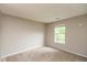 Bedroom with neutral walls and carpet, and a bright window at 11051 Oakridge Dr, Fishers, IN 46038
