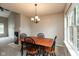 Dining area with chandelier, large window, and open to the living area and kitchen at 11051 Oakridge Dr, Fishers, IN 46038