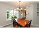 Cozy dining area with backyard views, chandelier lighting, and connection to kitchen at 11051 Oakridge Dr, Fishers, IN 46038