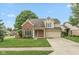 Charming two-story home with brick accents, a well-manicured lawn, and a two car garage at 11051 Oakridge Dr, Fishers, IN 46038