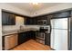 Modern kitchen with stainless steel appliances, granite countertops, and wood look flooring at 11051 Oakridge Dr, Fishers, IN 46038