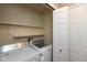 Efficient laundry room with white washer, dryer, storage shelves and closet at 11051 Oakridge Dr, Fishers, IN 46038