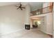 Open living room with fireplace, leading into a dining area, with lofted landing above at 11051 Oakridge Dr, Fishers, IN 46038