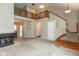 Open living room with staircase, fireplace, and an upstairs lofted landing, with dining area at 11051 Oakridge Dr, Fishers, IN 46038