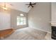 Bright living room with large windows, a fireplace, and high vaulted ceilings with ceiling fan at 11051 Oakridge Dr, Fishers, IN 46038