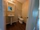 Bathroom featuring a pedestal sink, toilet, and updated flooring at 11343 Congaree Way, Indianapolis, IN 46235
