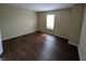 Bedroom with wood floors and a large window, featuring neutral colors at 11343 Congaree Way, Indianapolis, IN 46235