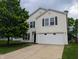 Two-story home with a two-car garage, tree in the yard, and vinyl siding at 11343 Congaree Way, Indianapolis, IN 46235