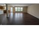 Open living area with wood floors and plenty of natural light from surrounding windows at 11343 Congaree Way, Indianapolis, IN 46235