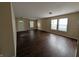 Living room features wood floors, three windows, and a view to the front door at 11343 Congaree Way, Indianapolis, IN 46235