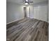 Spacious bedroom featuring sleek gray flooring, ceiling fan, and ample closet space at 1205 Meadow Ln, Lebanon, IN 46052