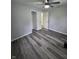 Open bedroom featuring new floors, modern ceiling fan, and doors to closet and hall at 1205 Meadow Ln, Lebanon, IN 46052