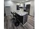 Charming kitchen with white cabinets, stainless appliances, gray counters, and breakfast bar at 1205 Meadow Ln, Lebanon, IN 46052