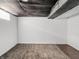 Unfinished basement with insulation on the ceiling and faux wood flooring at 1209 W 22Nd St, Anderson, IN 46016