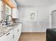 Bright kitchen featuring stainless steel sink, white cabinets and tiled backsplash at 1209 W 22Nd St, Anderson, IN 46016