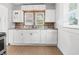 White kitchen cabinets, stainless steel sink and modern faucet with tiled floors at 1209 W 22Nd St, Anderson, IN 46016