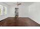 Open living room with hardwood flooring, ceiling fan, and ample natural light at 1209 W 22Nd St, Anderson, IN 46016