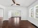 Bright living room with hardwood floors, ceiling fan, and great natural light at 1209 W 22Nd St, Anderson, IN 46016