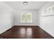 Spacious living room featuring two bright windows and hardwood floors at 1209 W 22Nd St, Anderson, IN 46016